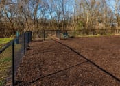 Thumbnail 5 of 28 - a tennis court with a fence and trees