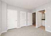 Thumbnail 22 of 28 - a bedroom with two closets and a door to a bathroom