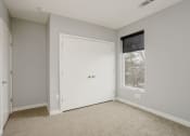 Thumbnail 23 of 28 - a bedroom with a white door and a window