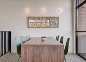 Thumbnail 12 of 26 - a meeting room with a wooden table and green chairs