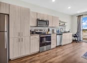 Thumbnail 4 of 16 - a kitchen with wooden cabinets and stainless steel appliances