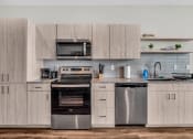 Thumbnail 14 of 16 - a kitchen with stainless steel appliances and wooden cabinets
