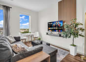 Thumbnail 12 of 16 - a living room with a couch and a tv
