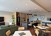 Thumbnail 13 of 31 - A modern kitchen with a dining table and chairs.