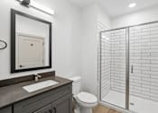 Thumbnail 23 of 31 - A bathroom with a toilet, sink, and shower.