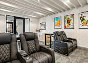 Thumbnail 16 of 31 - A row of black leather recliner chairs are lined up in a waiting room.