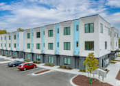 Thumbnail 21 of 23 - a view of a building with cars parked in front of it