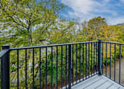 Thumbnail 19 of 23 - a balcony with a view of a garden and trees