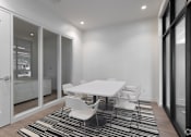 Thumbnail 8 of 23 - a dining room with a white table and chairs