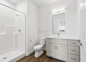 Thumbnail 23 of 26 - A white bathroom with a toilet, sink, and bathtub.