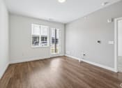 Thumbnail 17 of 26 - A room with wooden flooring and a window with blinds.