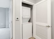 Thumbnail 21 of 28 - a small laundry room with a washer and dryer in a closet