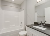 Thumbnail 24 of 28 - a bathroom with a sink toilet and a tub