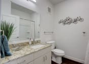 Thumbnail 13 of 30 - a bathroom with a sink and a toilet and a mirror