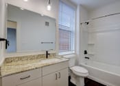 Thumbnail 21 of 30 - A bathroom with a sink, toilet, and bathtub.