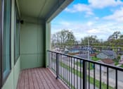 Thumbnail 24 of 30 - A balcony with a black railing and a view of a residential neighborhood.