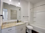 Thumbnail 30 of 30 - A white bathroom with a marble countertop and a large mirror.