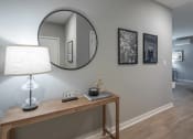 Thumbnail 14 of 28 - a mirror and a lamp on a table in a living room