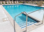 Thumbnail 15 of 26 - A swimming pool with a metal ladder.