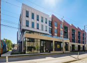 Thumbnail 6 of 26 - an image of the front of a building with a blue sky in the background
