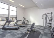 Thumbnail 14 of 26 - two treadmills and other exercise equipment in a gym with windows