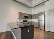 Thumbnail 22 of 26 - a kitchen with an island and stainless steel appliances