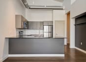 Thumbnail 23 of 26 - a kitchen with a large island and stainless steel appliances