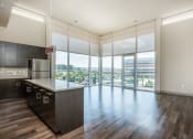 Thumbnail 1 of 33 - an open kitchen with a large window overlooking a city