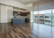 Thumbnail 2 of 33 - an open kitchen with a large window and a wood floor