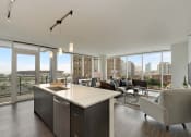 Thumbnail 2 of 22 - a kitchen and living room with a view of the city