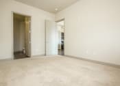 Thumbnail 5 of 33 - a living room with a carpeted floor and a door to a bedroom