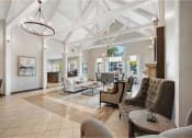 Thumbnail 14 of 24 - a large living room with couches and chairs