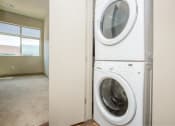 Thumbnail 6 of 33 - a front loading washer and dryer in a laundry room