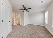Thumbnail 48 of 48 - A room with a ceiling fan and carpeted floor.