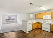 Thumbnail 14 of 58 - A kitchen with white appliances and wooden cabinets.