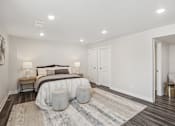 Thumbnail 8 of 16 - A bedroom with a large bed and a bench.