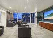 Thumbnail 16 of 22 - a large living room with couches and a large screen tv
