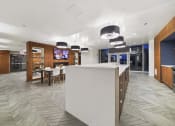 Thumbnail 17 of 22 - a view of a kitchen and dining area with a tv