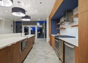 Thumbnail 18 of 22 - a kitchen with a long counter top and a sink