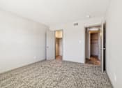 Thumbnail 19 of 35 - A room with a carpeted floor and two doors.