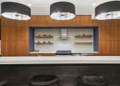 Thumbnail 19 of 22 - a kitchen with wood cabinets and a white counter top and black stools