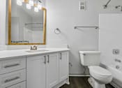 Thumbnail 15 of 61 - A white bathroom with a gold framed mirror and a towel rack on the wall.