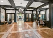 Thumbnail 10 of 24 - a large lobby with chairs and a table and a chandelier