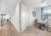 Thumbnail 3 of 35 - a white office with a desk and a mirror on the wall