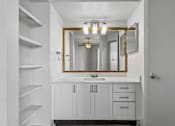 Thumbnail 17 of 61 - A bathroom with a white sink and a mirror above it.