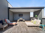 Thumbnail 75 of 95 - a patio with furniture and a tv on the wall