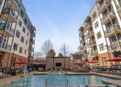 Thumbnail 5 of 95 - Apartments for Rent in
Germantown, Nashville, TN -
Peyton Stakes - Resort-Style Pool
with Submerged and Poolside
Lounge Seats, Hot Tub, Red
Umbrellas, and Surrounding
Apartment Buildings.
