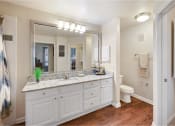 Thumbnail 7 of 24 - a bathroom with a large mirror and a sink and a toilet
