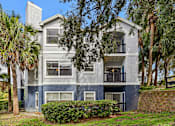Thumbnail 20 of 61 - A two-story building with a balcony on the second floor.