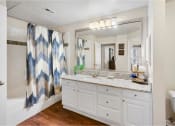 Thumbnail 6 of 24 - a bathroom with a sink and a shower and a mirror